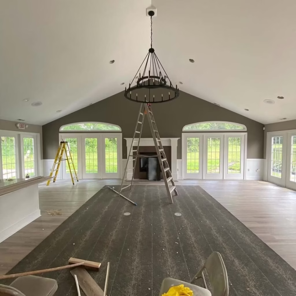 Large room with vaulted ceiling during commercial painting