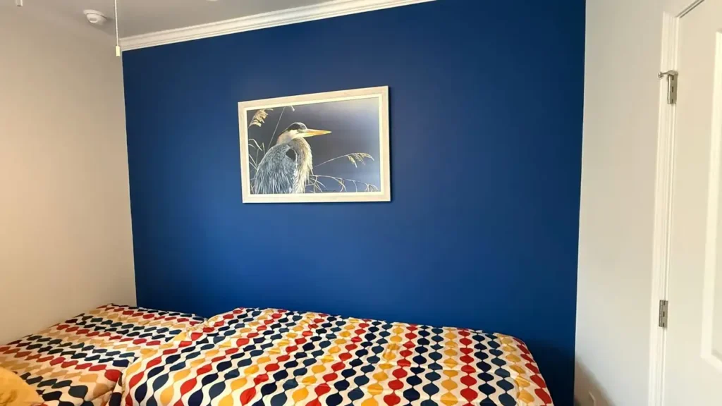 Bedroom with a navy blue accent wall