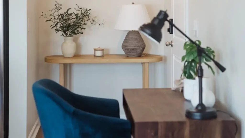 Home office corner with white walls, wood desk and blue chair