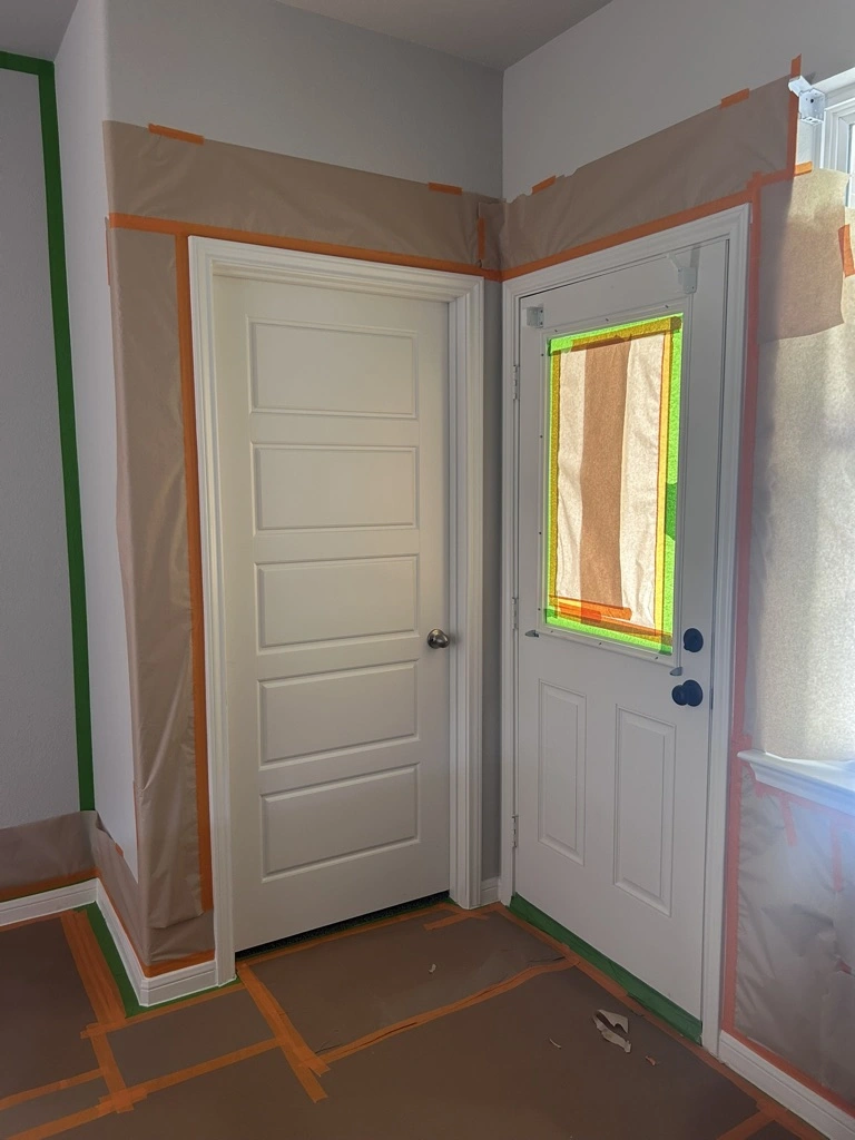 Doorways masked with plastic and tape before interior painting