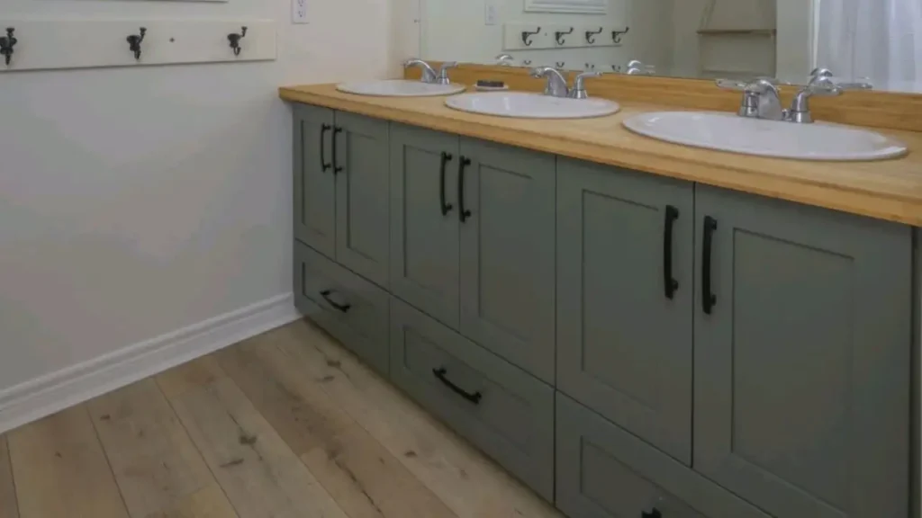 Bathroom vanity with sage green painted cabinets