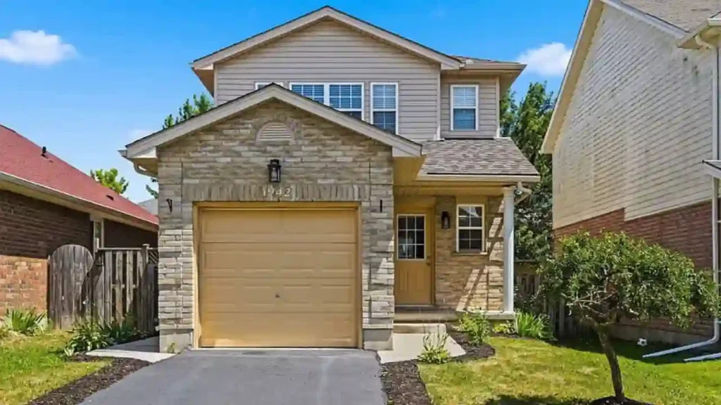 Two-story house with stone front and tan siding
