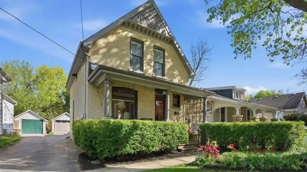 Two-story yellow house with a covered front porch